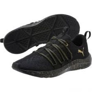 Black and gold Puma tennis shoes